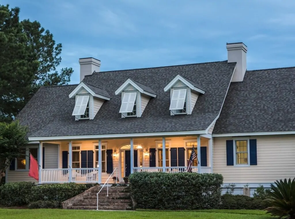 A beautiful finished home project by The Roof Tiger showing the complex detail of how to shingle a roof around three gabled dormers and multiple chimneys.