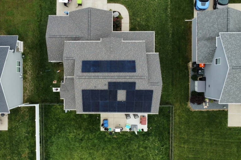 A detailed grey shingle roof with solar panels professionally installed by ROOF TIGER.