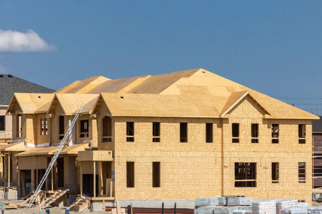 Plywood and oriented strand board or chip board roof and exterior wall sheathing of a residential construction project with many windows openings