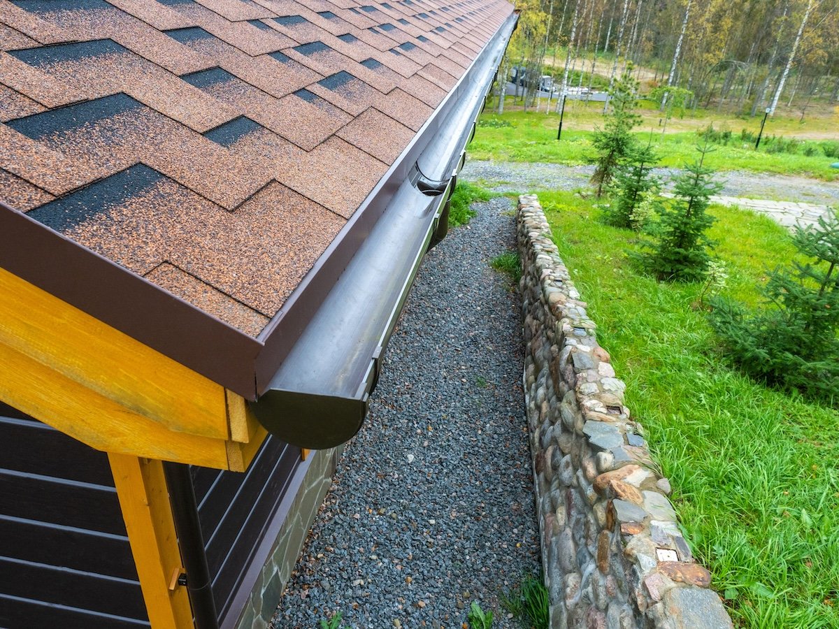 Holder gutter drainage system on the roof. Drain on the roof of the house. Roof drainage. Water drainage from the roof.