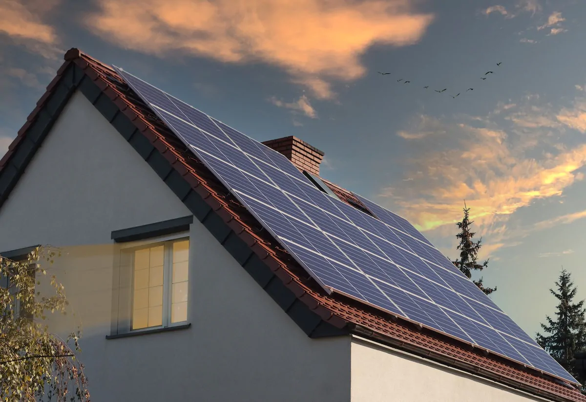 Beautiful new houses with solar panels in a suburban area. Evening view.