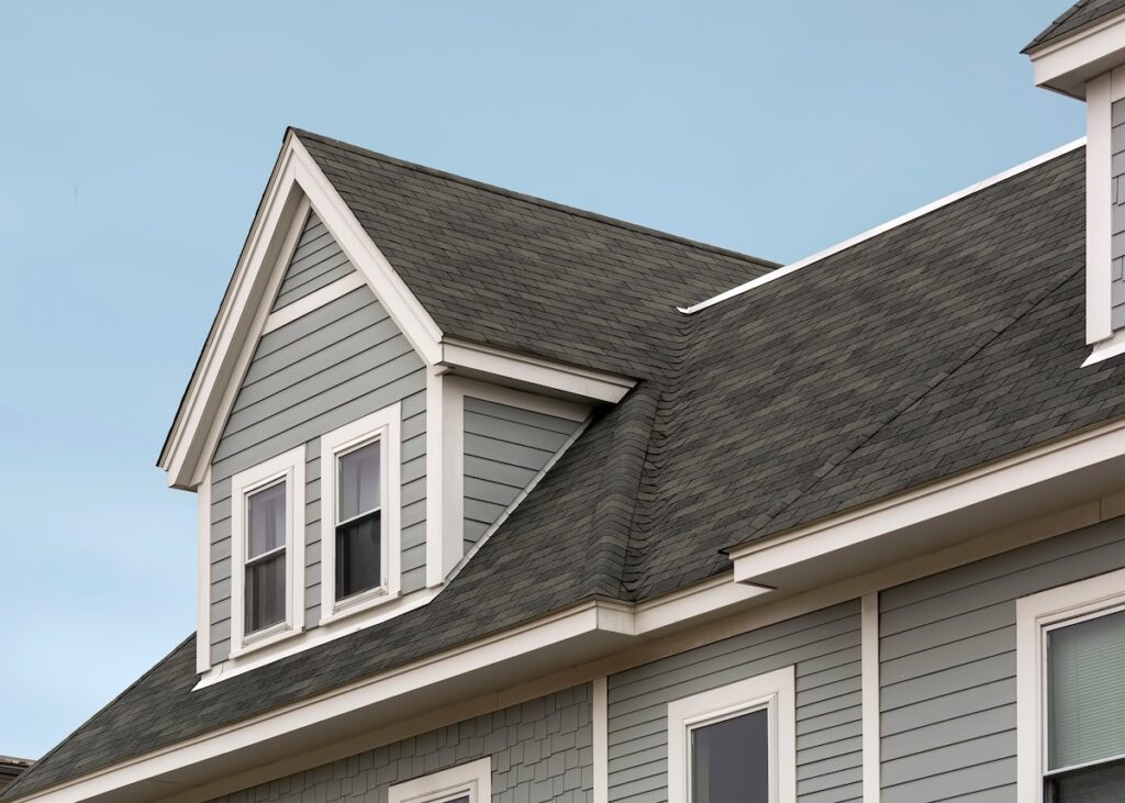 Detailed view of a gable-style dormer window on a sloped roof of a newly built family house