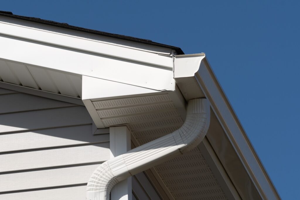 colonial white gutter guard system, fascia, drip edge, soffit providing ventilation to the attic roof line