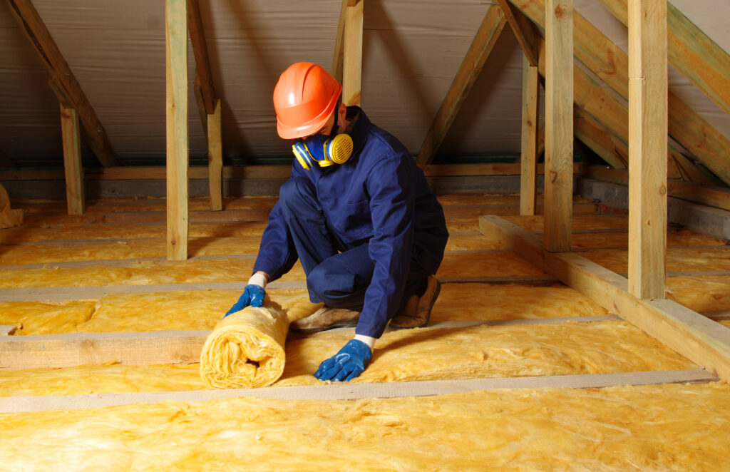 roof insulation Worker insulate the attic with mineral wool