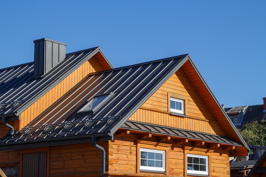 types of metal roofing Wooden houses. Classic metal roof. Colorful Houses