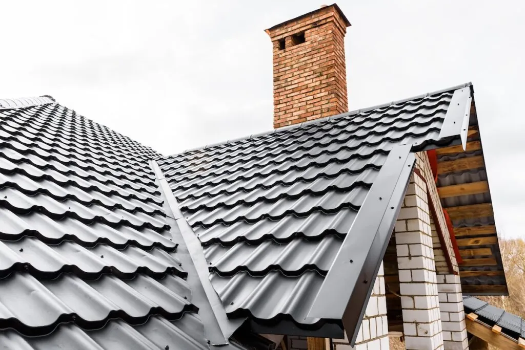 types of metal roofing Construction of the roof of the house. Metal tiles.