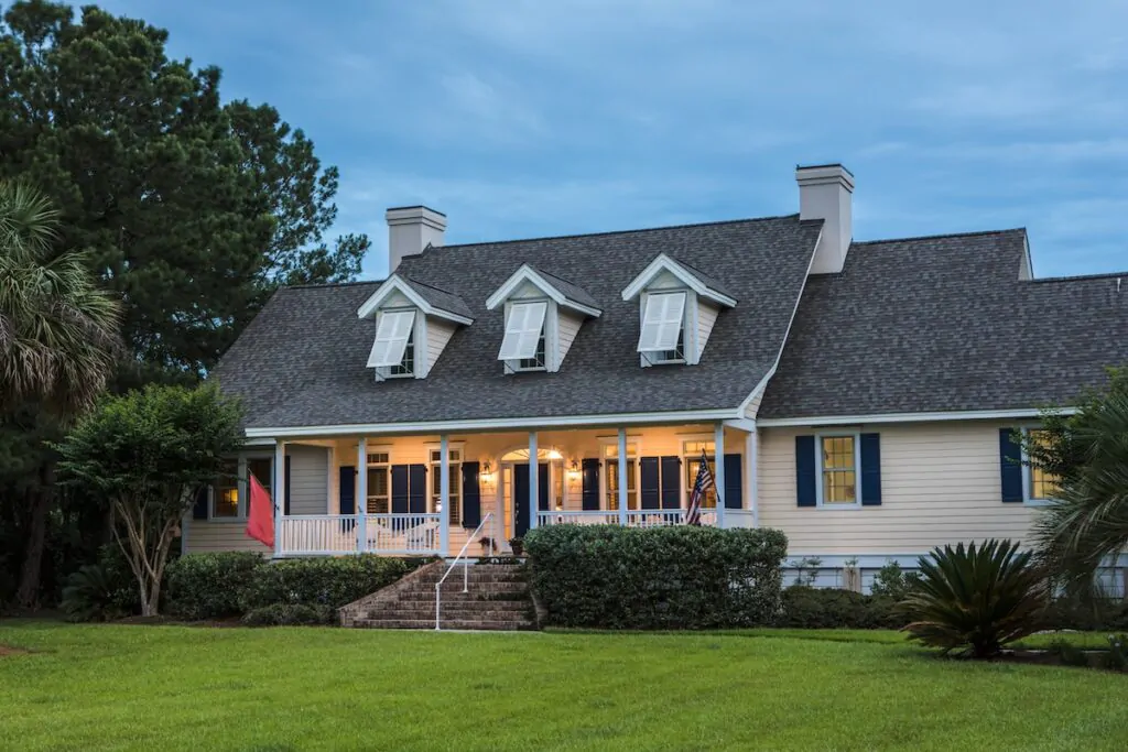 gaf roofing Beautiful home lit up at twilight.