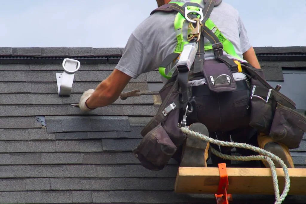 roof repair construction worker roofer man roofing security rope