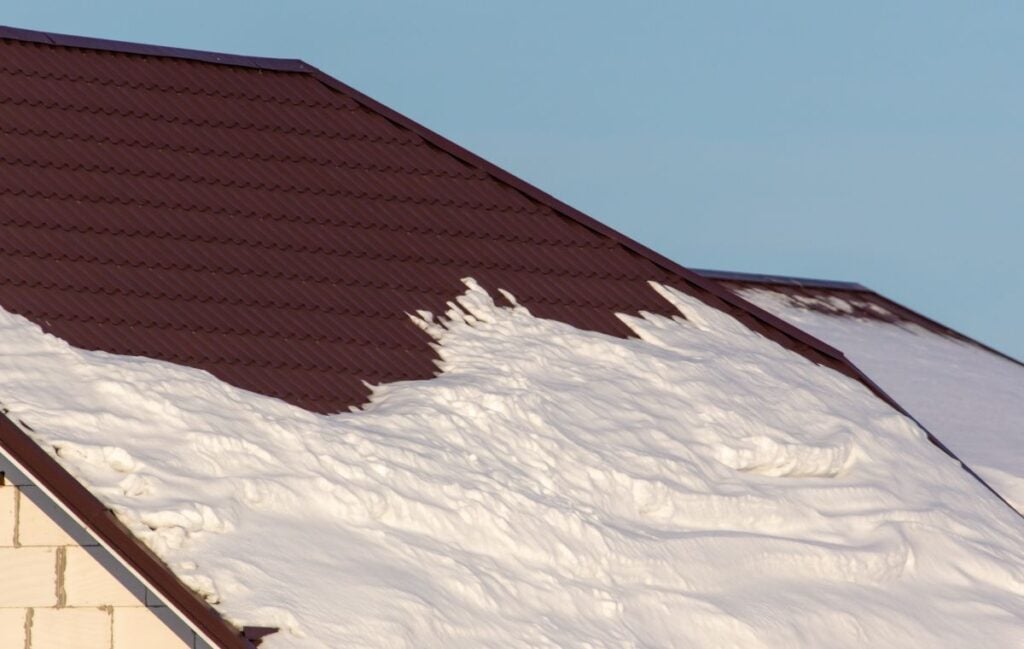 Brick house with snow on the roof