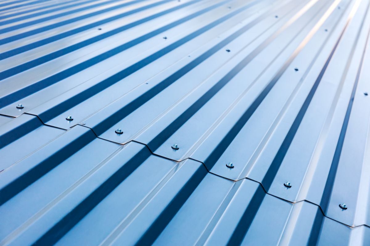 blue corrugated metal roof with rivets, industrial background