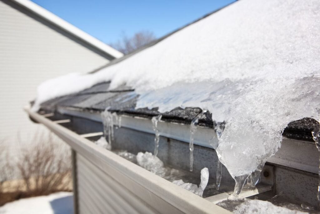 roof and gutters covered in snow and ice