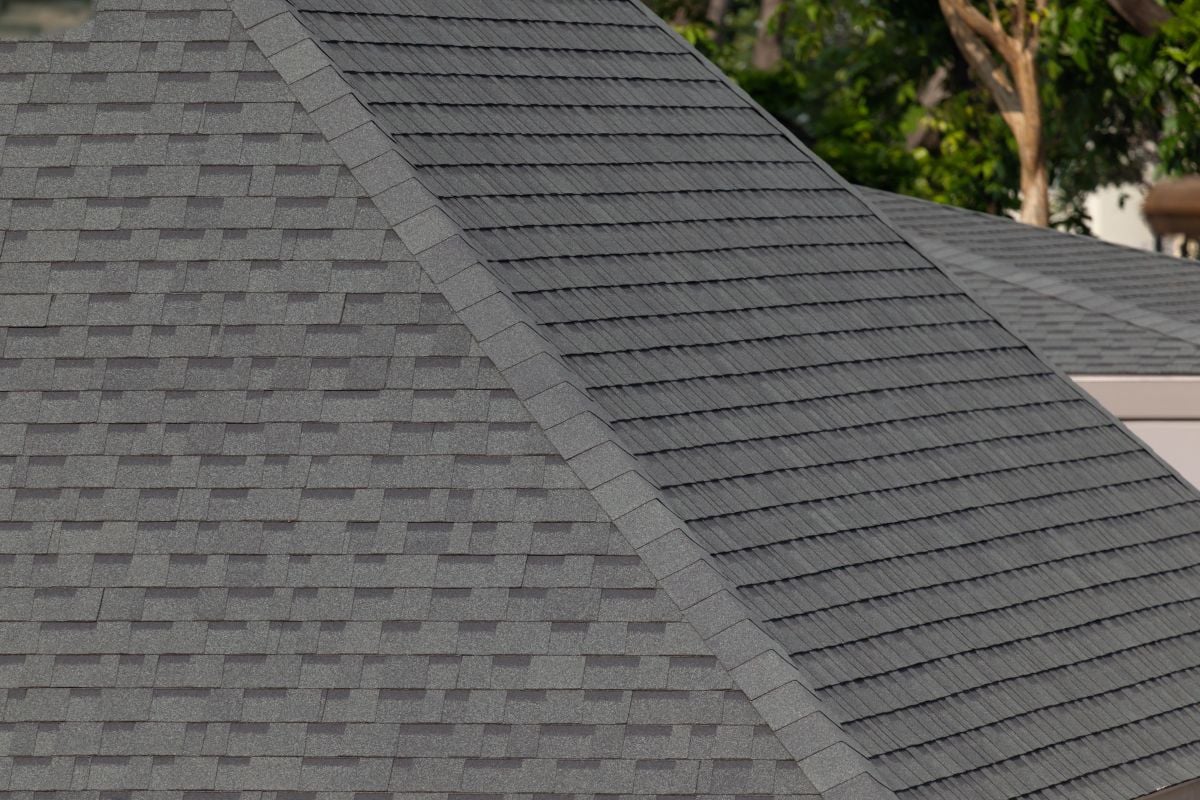 Dark gray shingles line a sloped roof, with neat rows. Energy efficiency