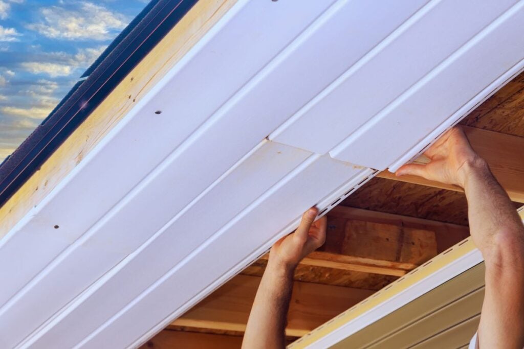 Installation of vinyl soffit plastic boards on ceiling new home