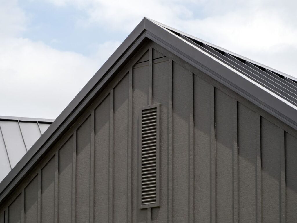 Modern gable roof with vertical cladding and ventilation grille