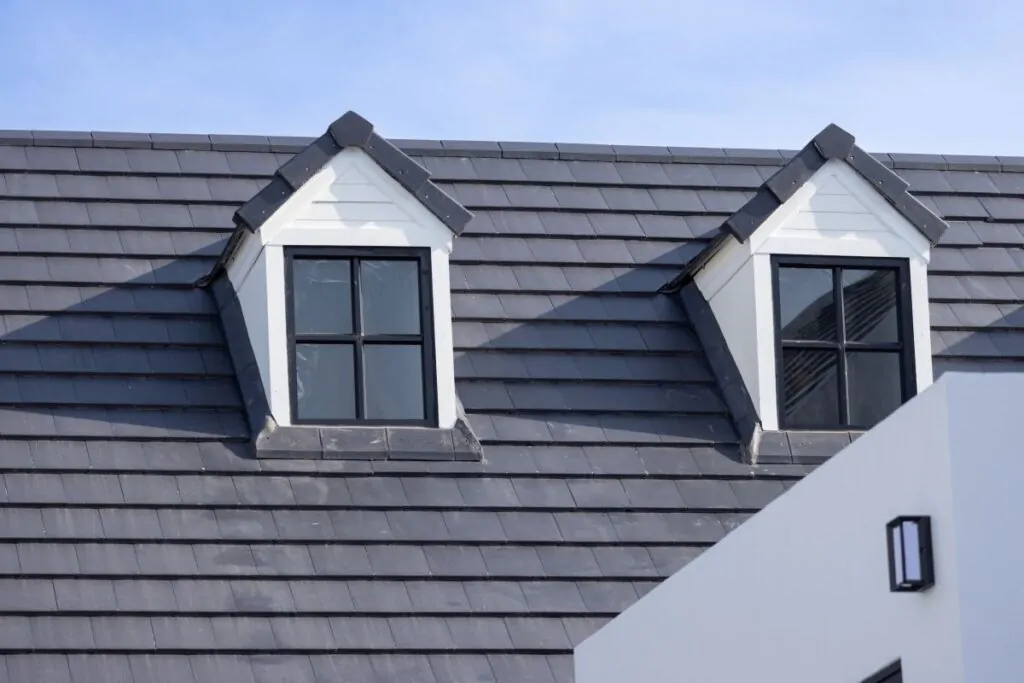 white house with black slate tile roof