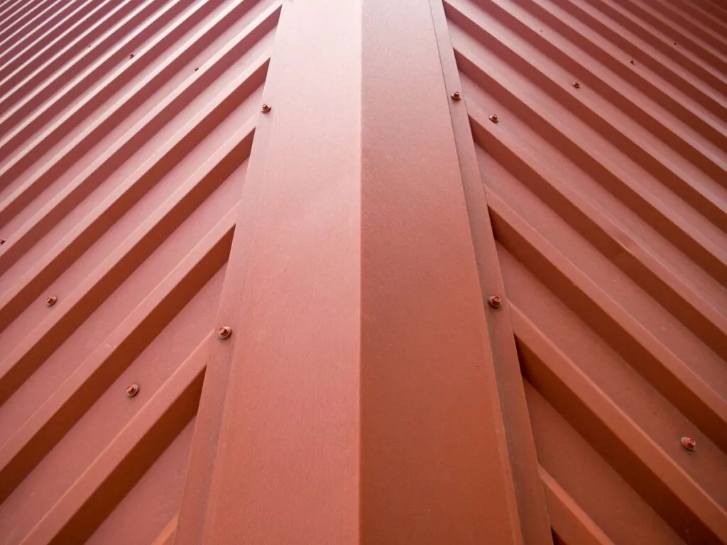 Fragment of the roof of a building covered with a metal