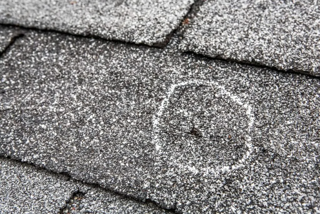 close-up view of shingle damage after hail storm